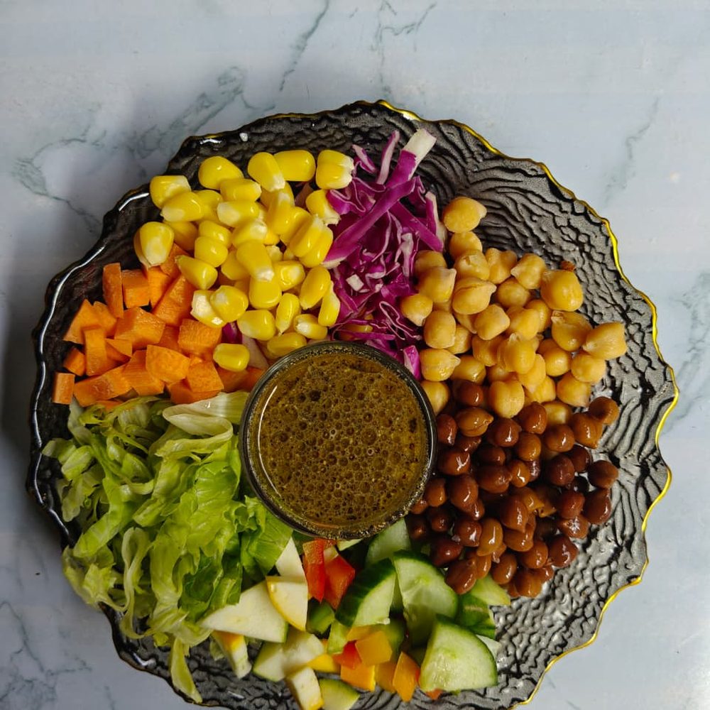 Corn Chickpea Salad with carrot, red cabbage, lettuce and a herb dressing